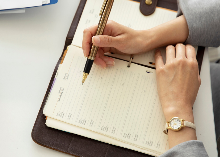 financial advisor taking notes during consultation